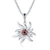 Pendentif Edelweiss Salem en argent 925 mâte et brillant avec zircons noirs et grenats modèle by White Alpina. Livré dans un écrin avec une chaîne.
